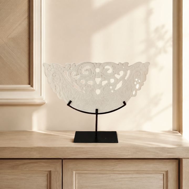 Large white cut-out sandstone sculpture styled in a warm interior