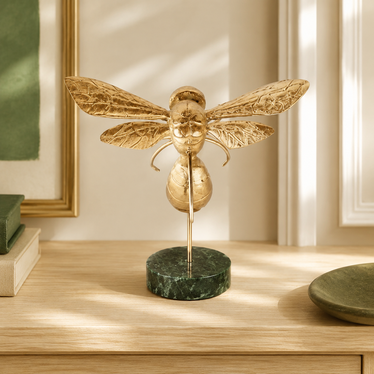 Medium gold bumblebee on marble base styled in a warm interior