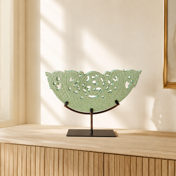 Medium green cut-out sandstone sculpture styled in a warm interior