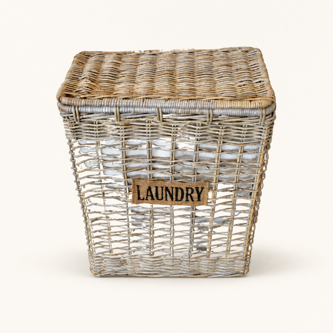 Natural laundry basket with liner on warm ivory background