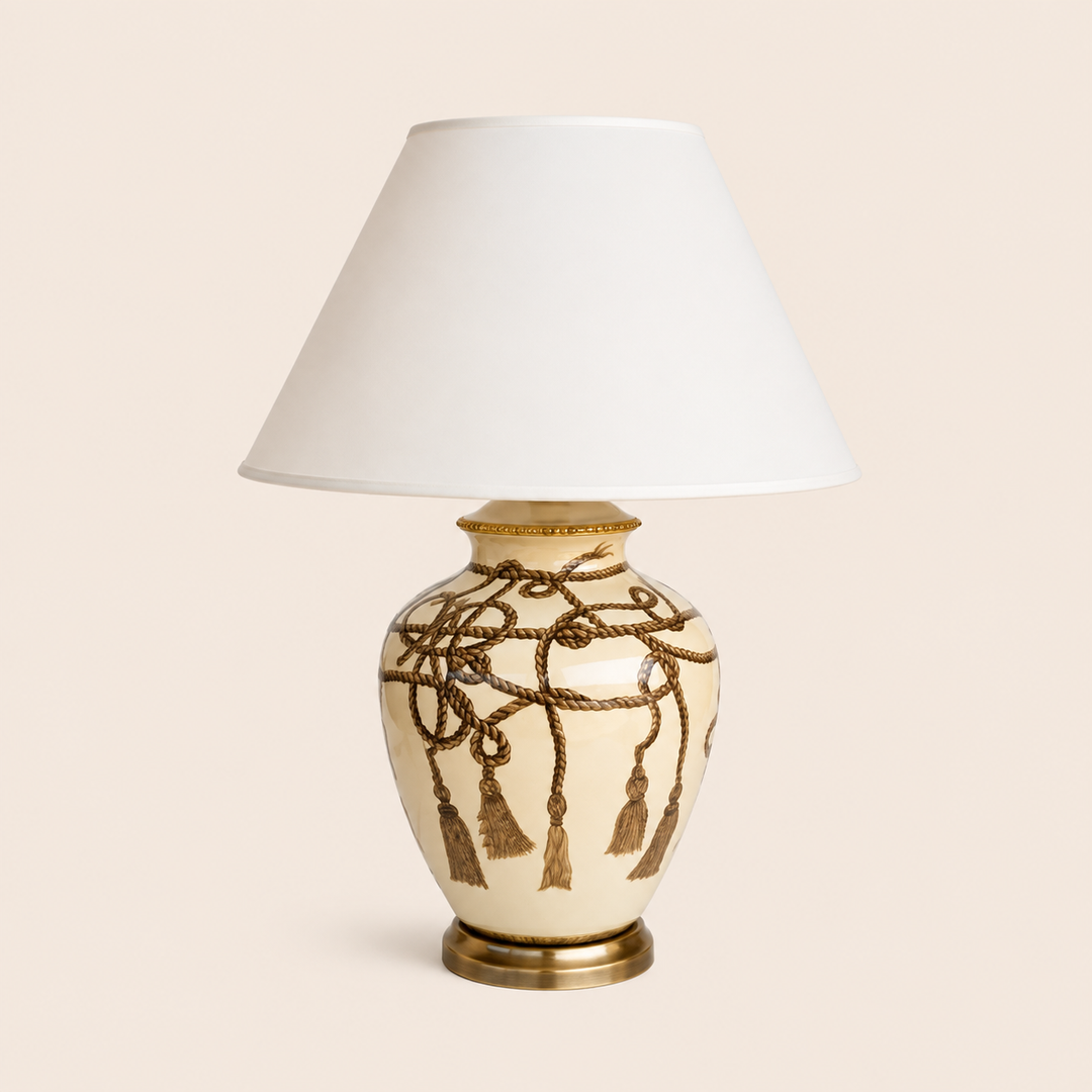 Rope tassel lamp with off-white shade on warm beige background