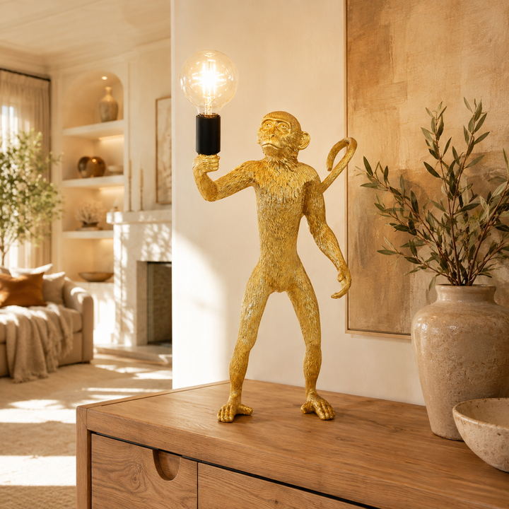 Standing gold resin monkey lamp in warm luxury interior