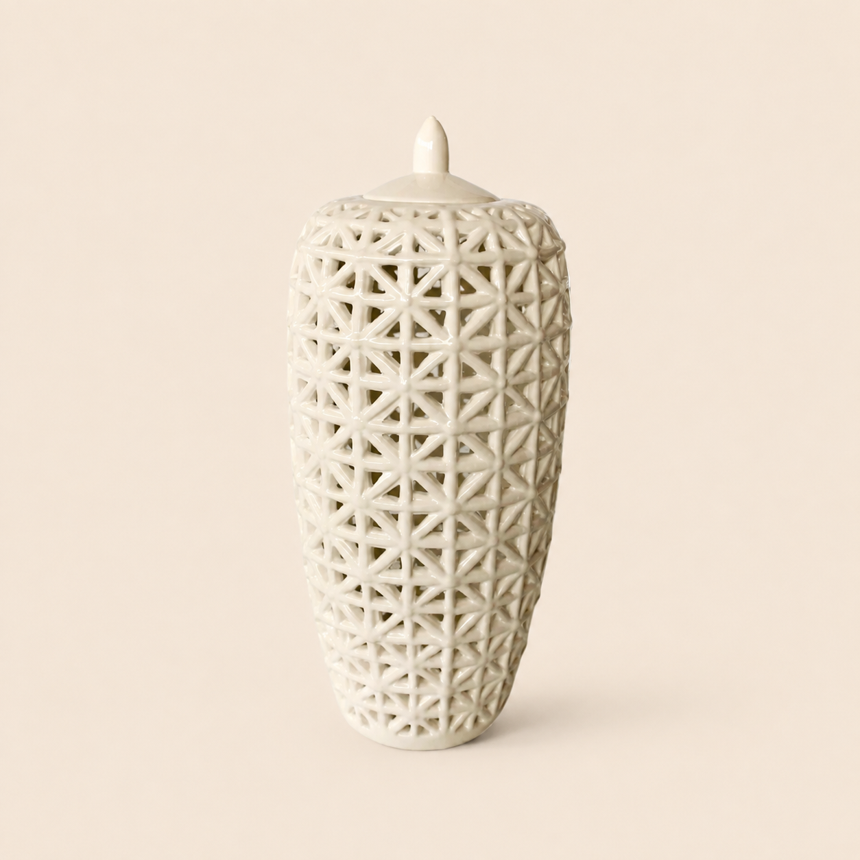 Tall white criss-cross cut-out jar with lid on warm beige background