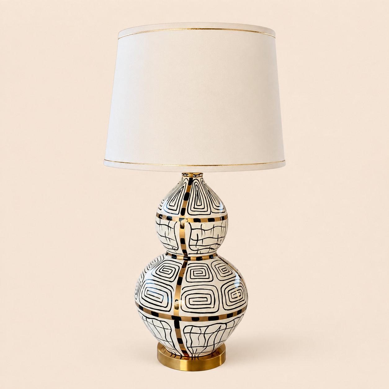 White black and gold squiggle lamp on warm beige background