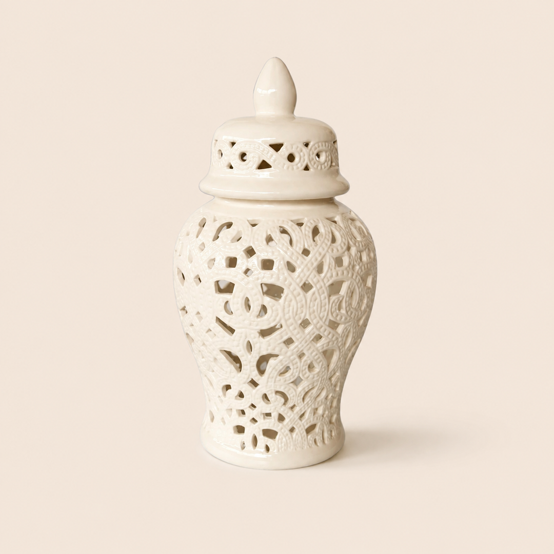 White cut-out ginger jar with braided design on warm beige background