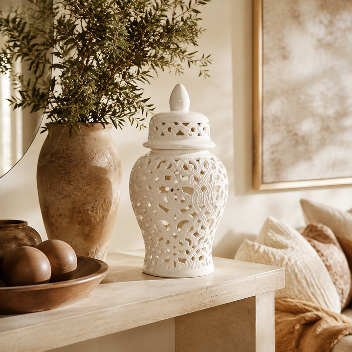 White cut-out ginger jar with braided design in warm luxury interior