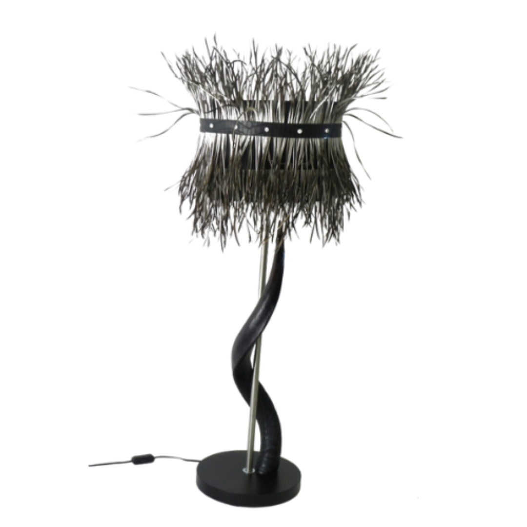 Exquisite Black Kudu Horn Lamp with Splitgoose Feather Shade
Bring the majesty of the African savannah into your home with this stunning lamp. Crafted from beautiful black kudu horns and paired with a striking splitgoose feather shade, this piece is a true masterpiece of South African craftsmanship. Unique Boys.