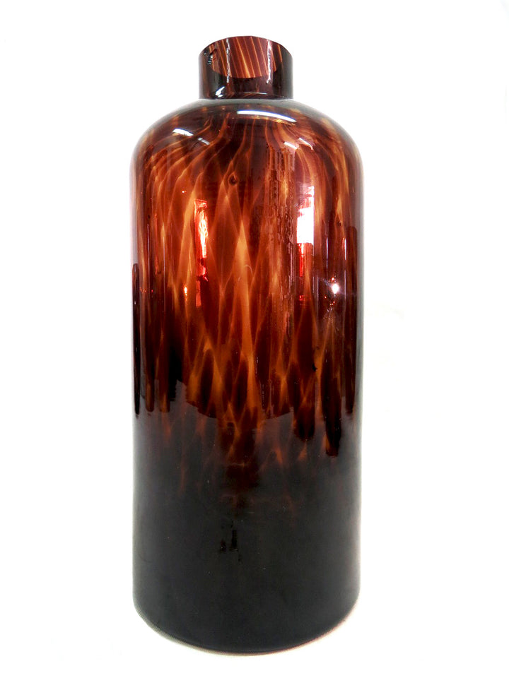 Introducing the Exquisite Oro Vase from Unique Boys
Elevate your home decor with this stunning, one-of-a-kind Oro Vase, expertly crafted with a mesmerizing tortoise shell design glass. Its unique jar/bottle shape adds an air of sophistication, making it a perfect conversation starter for any living space.